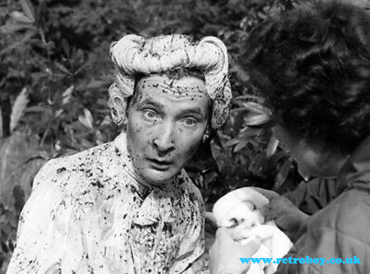 Kenneth Williams getting a clean up after a splash in the cesspit on the set of 'Carry On Don't Lose Your Head' (1966)
