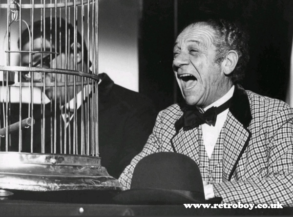 Sid James finds it hilarious that the great Oozlum bird has absconded in a still from 'Carry On Up the Jungle' (1970).