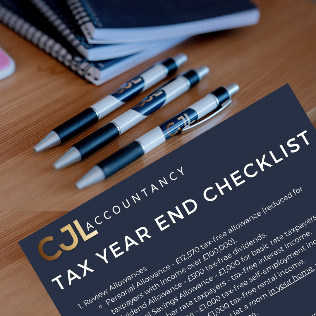 Desk with notebooks, CJL branded pens and a CJL branded tax year end checklist