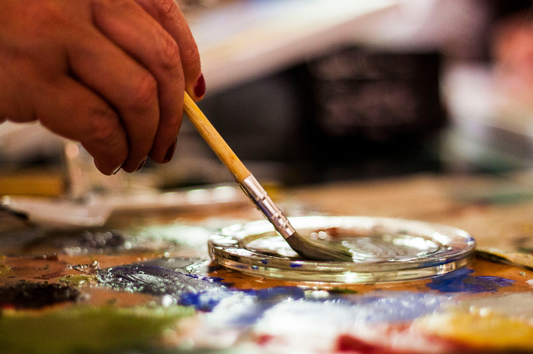 Hand holding a paintbrush