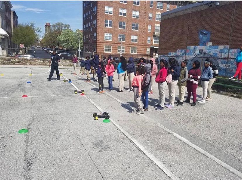 Students outside getting ready to race cars.