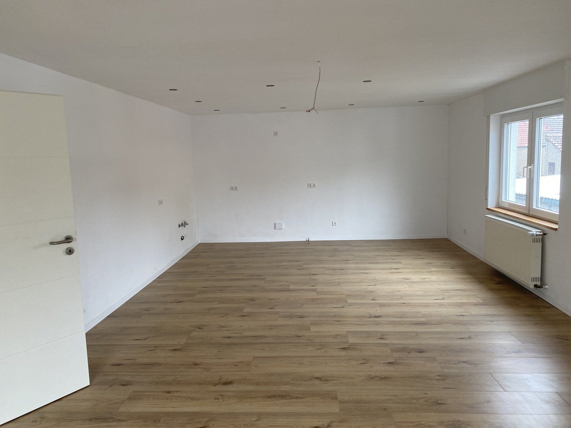 Renovierter Wohnraum mit Bodenverlegung und modernen Wandelementen in Helmstadt – Innenausbau von RS Bau & Immobilien.
