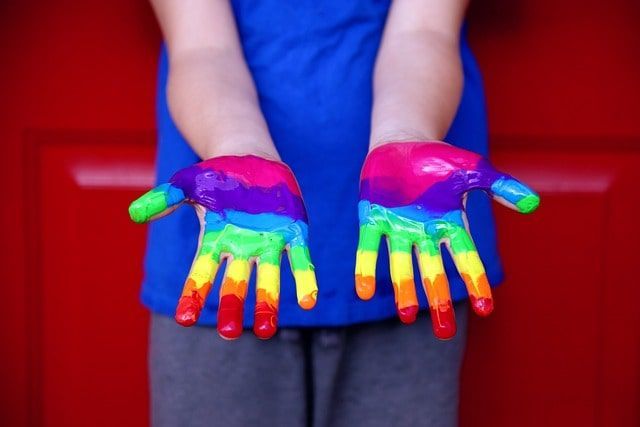 Rainbow painted hands - LGBTQ Affriiming
