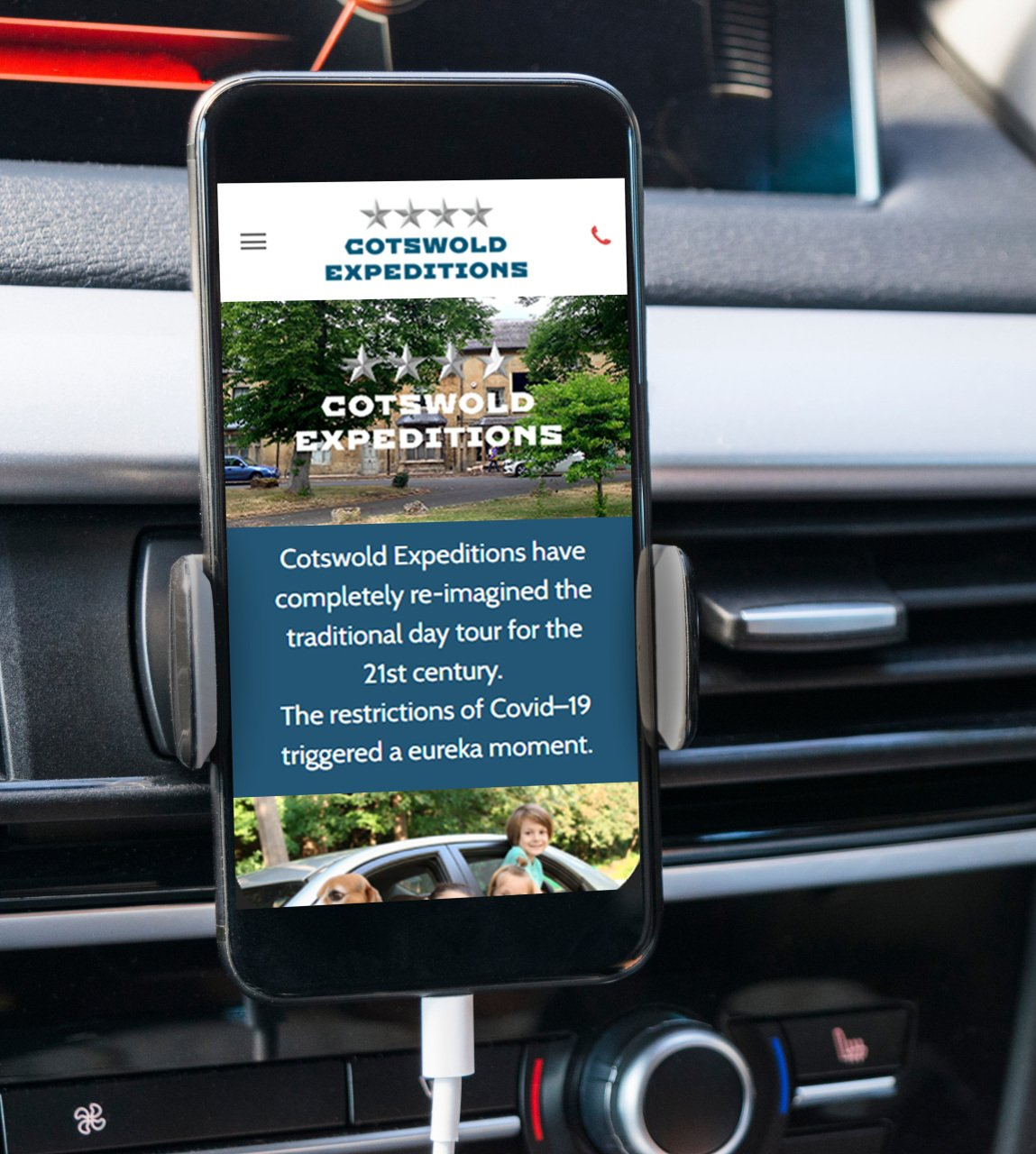 Image of an iPhone in a holder in a car displaying the Cotswold Expedition Website
