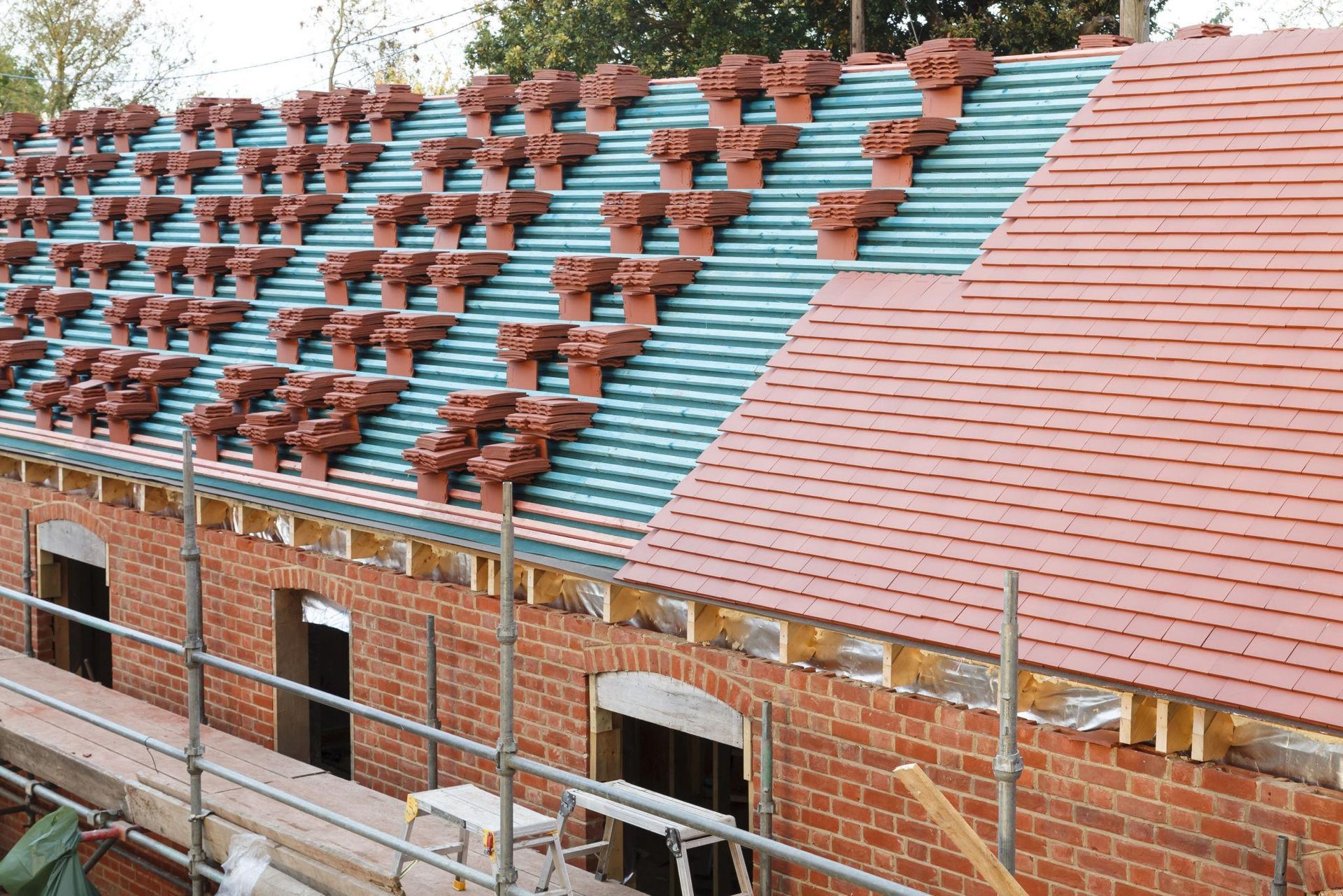 Re-roofing in Exeter with professional roofing contractors installing new roof tiles on a residential property in Devon