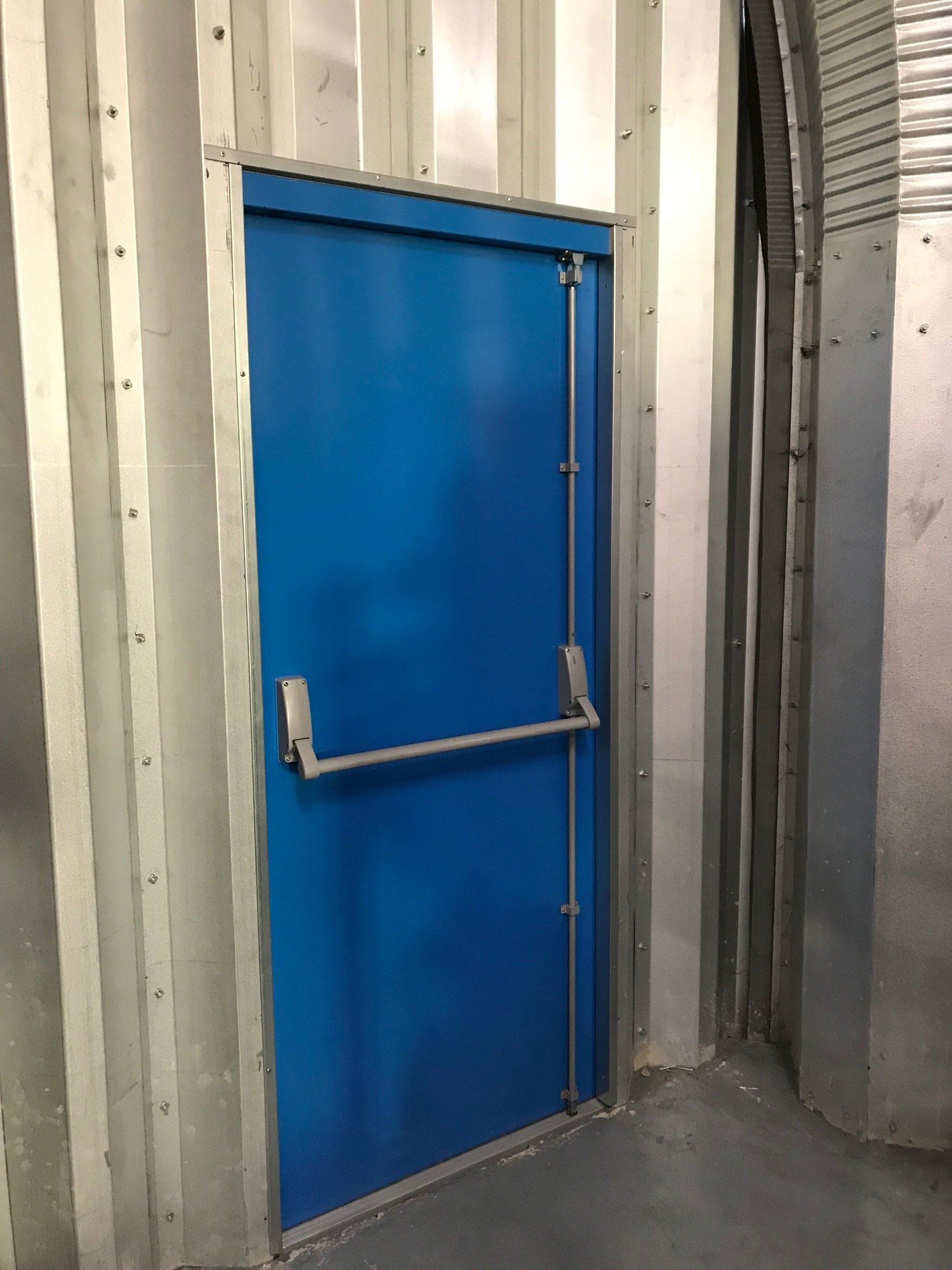 Blue Steel Fire Exit Door - Installed by Cambridge Door Services Ltd