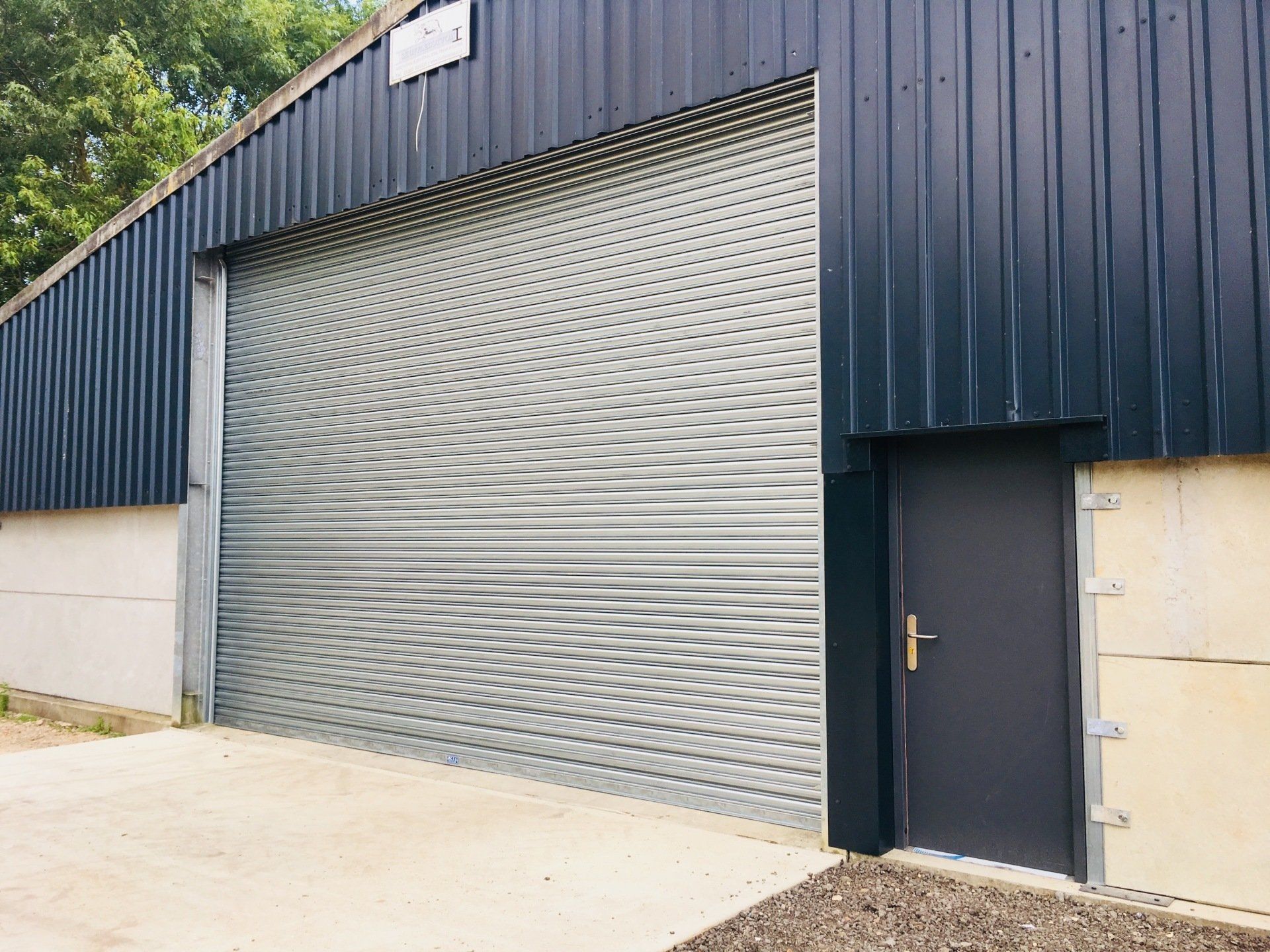 Single Skin Roller Shutter and Steel Personnel Door - Installed by Cambridge Door Services Ltd