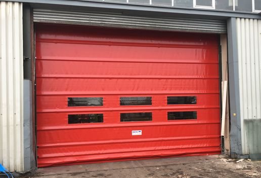 Red Rapid Fold Door - Installed by Cambridge Door Services Ltd