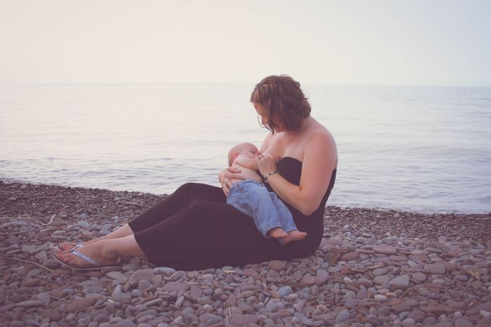 women nursing by lake