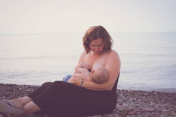 women nursing by lake