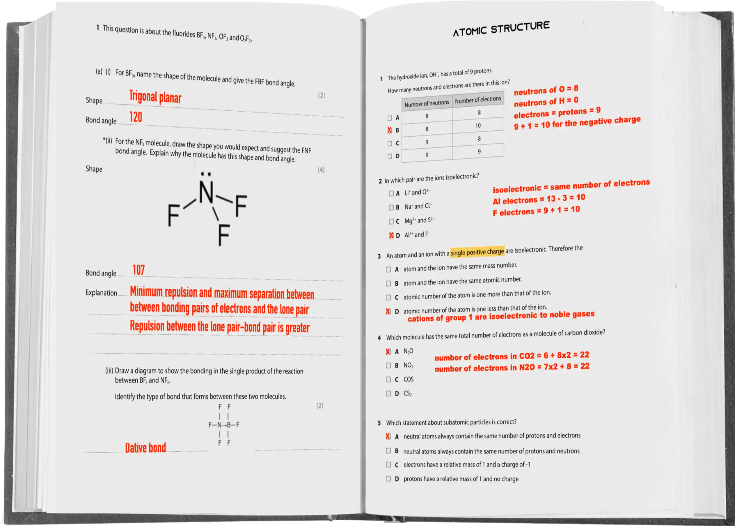 An opened chemistry textbook displays questions and answers on atomic structure and molecular bonding.