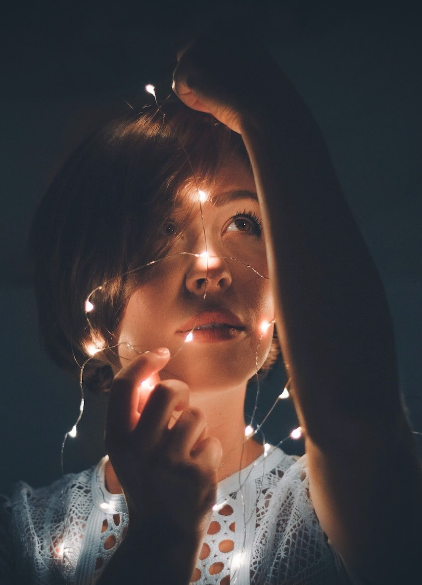 Image of a person holding a string of lights.