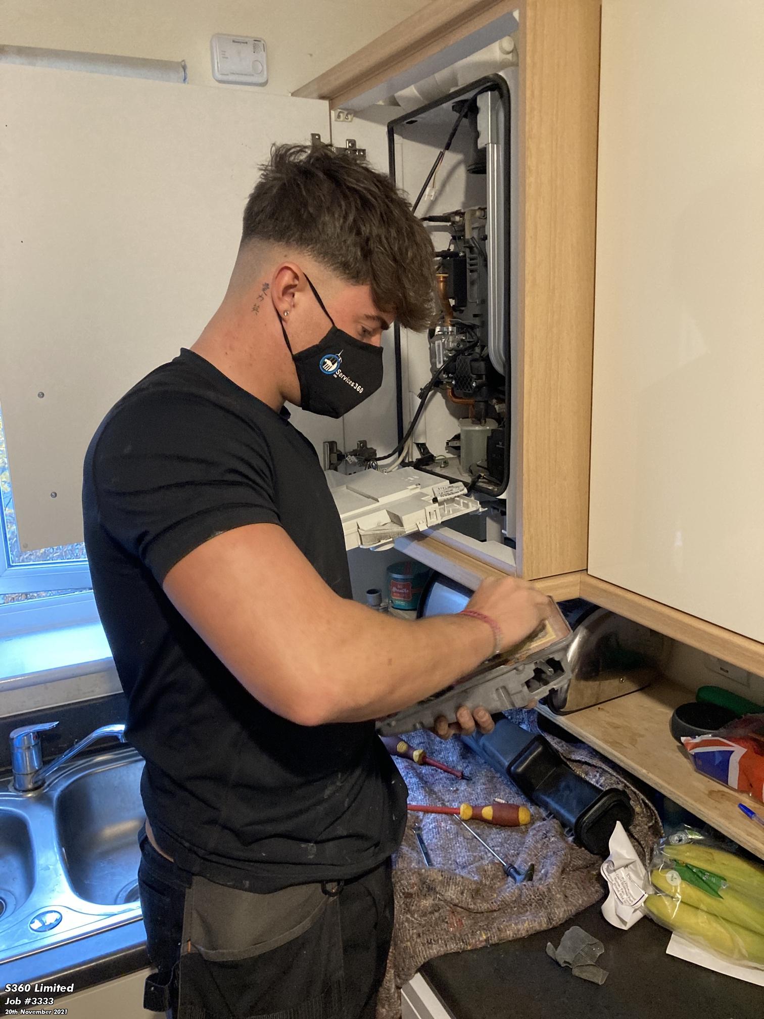 Professional fixing a central heating system