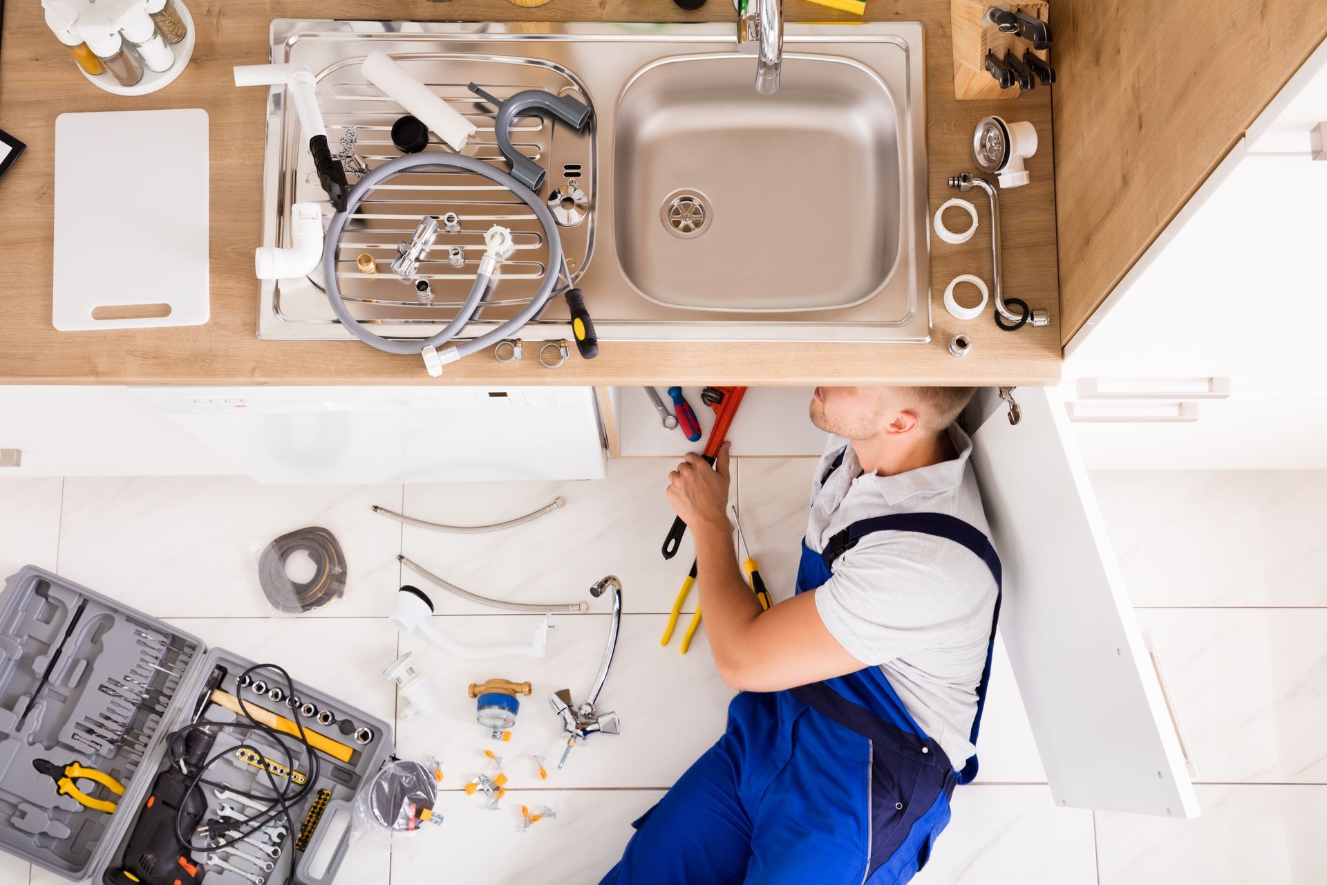Plumber fixing a domestic sink