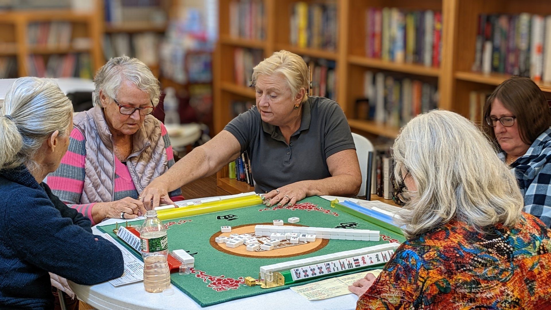 Joan coaching one Mah Jongg player at Senior Center, DE