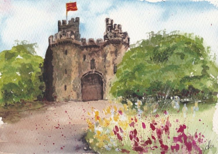 lancaster castle loose watercolour painting on a sunny day by lidia ranns. there are flowers in the foreground