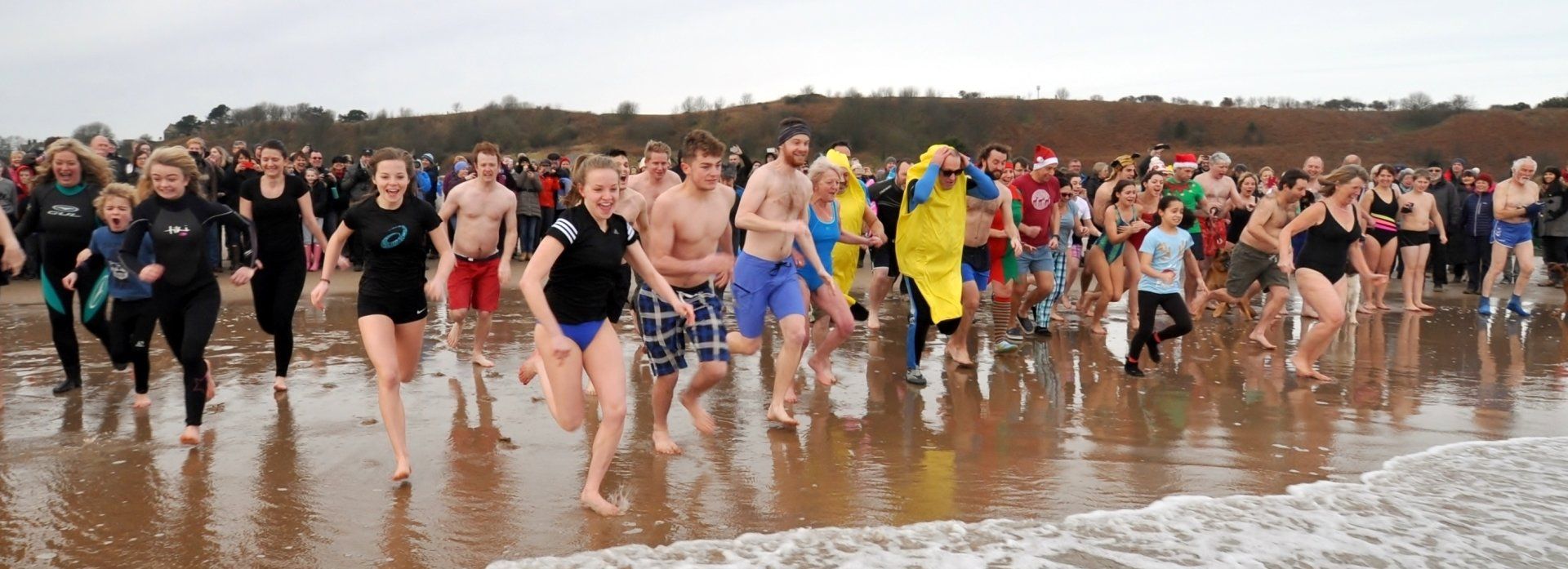 New Year's Day swimmers rush towards the sea New Year's Day swimmers rush towards the sea