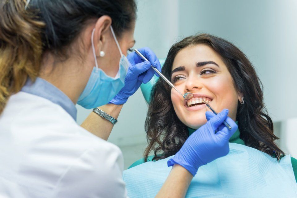 girl getting her teeth checked