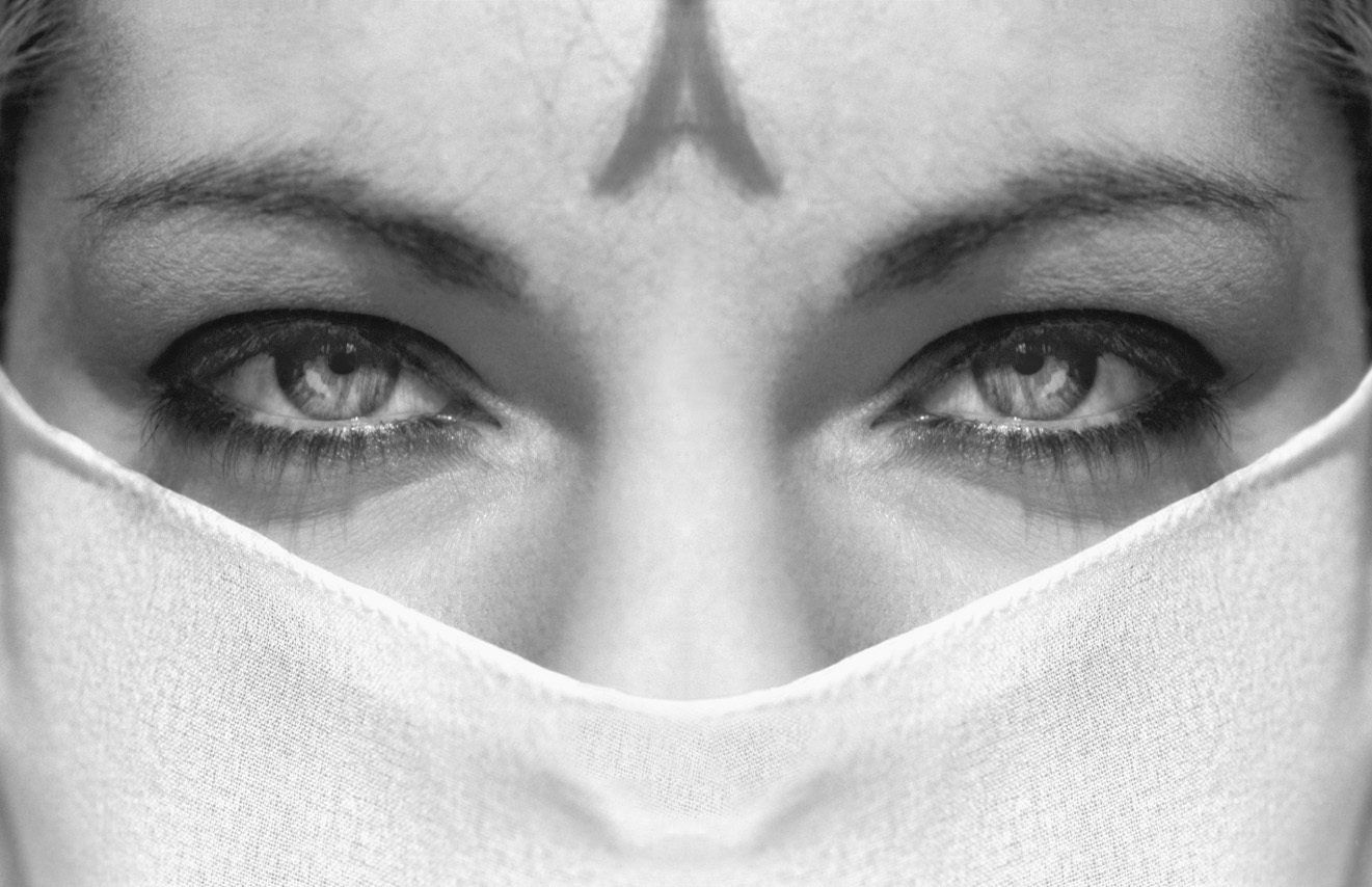 Thierry Aguiar, photographe Bordeaux  : photo en Gros plan des yeux de Karen, avec un foulard blanc autour de la bouche,  et l'ombre des cheveux formant un A sur le front.