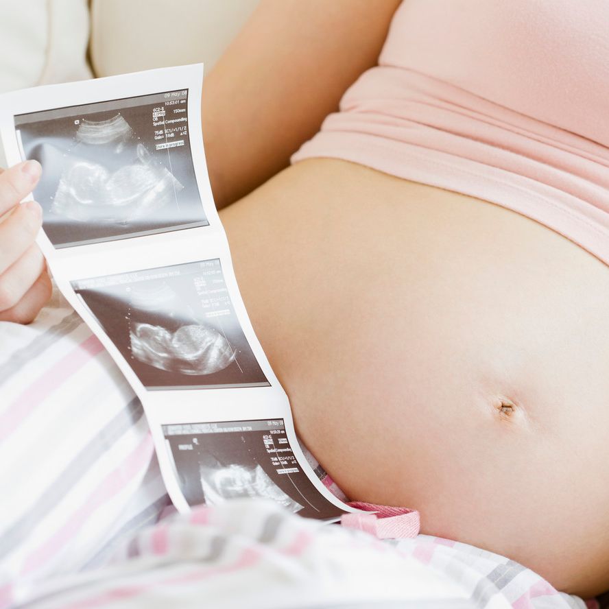 Pregnant belly with ultrasound images