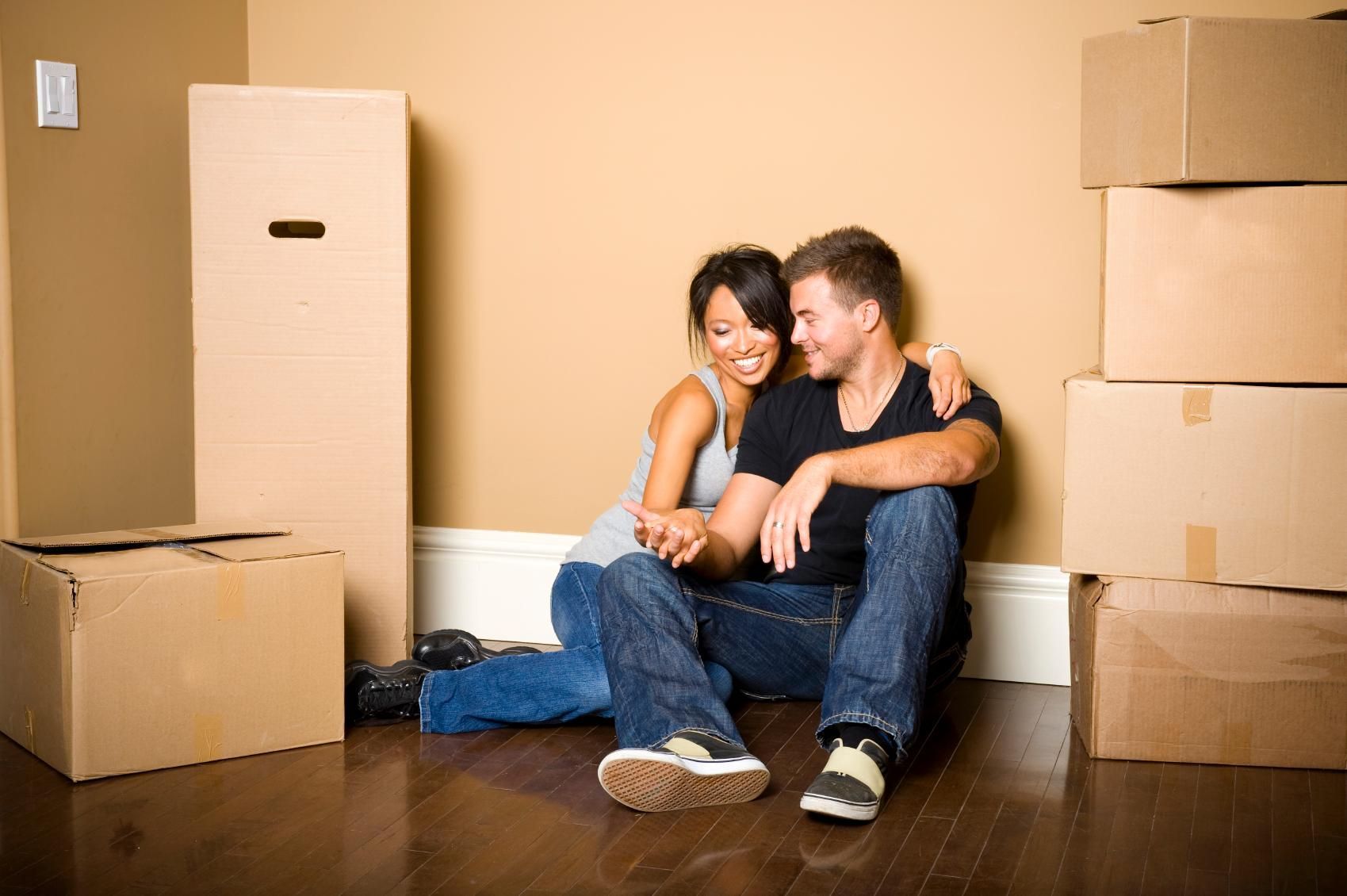 First time buyers in new home surrounded by boxes