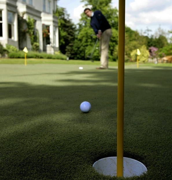 man putting on putting green