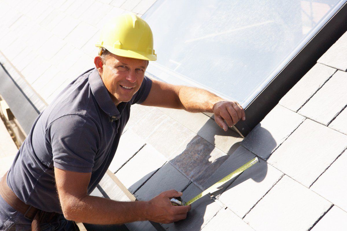 Roofer fixing slate roof