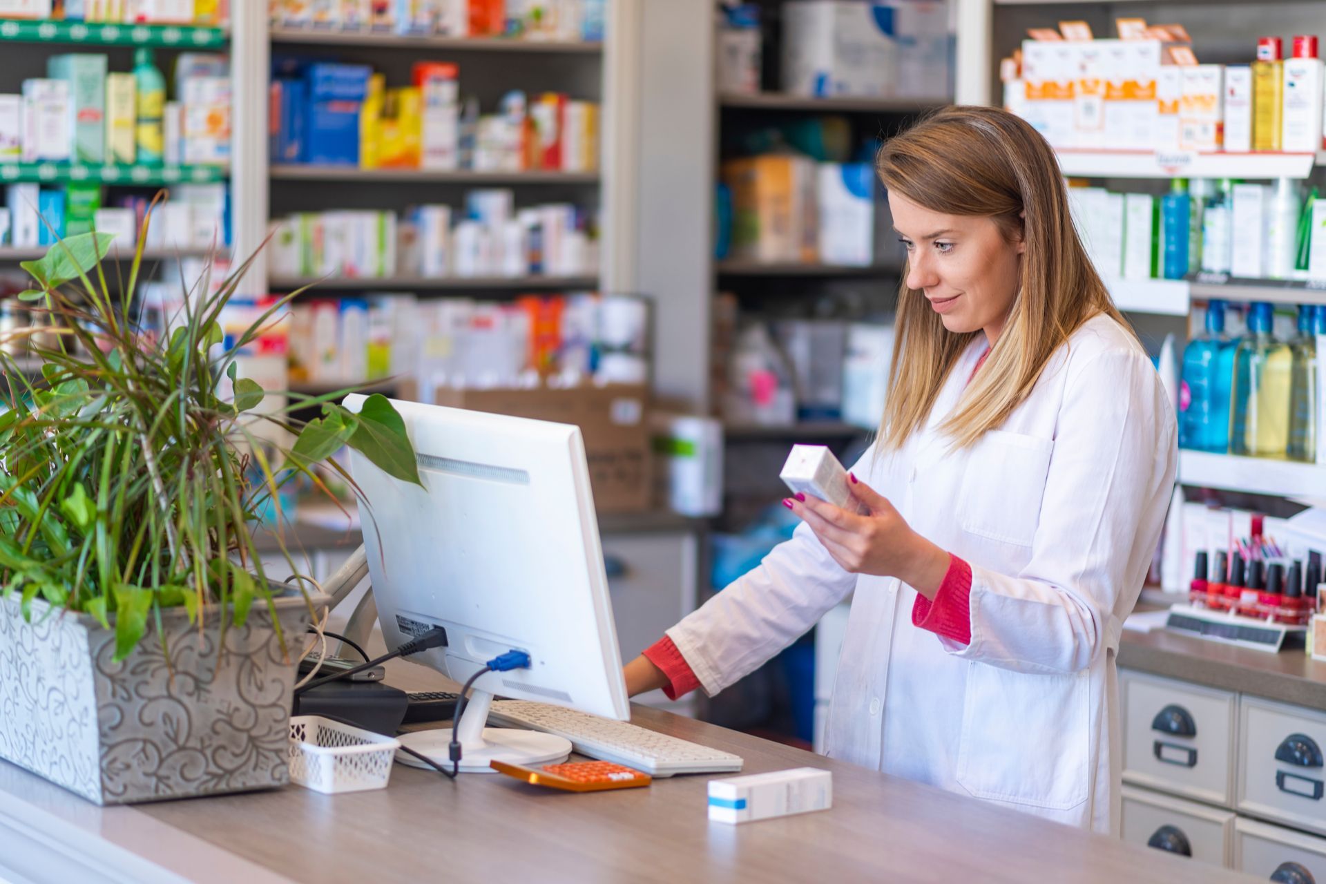 a pharmacist looking at a prescription bottle