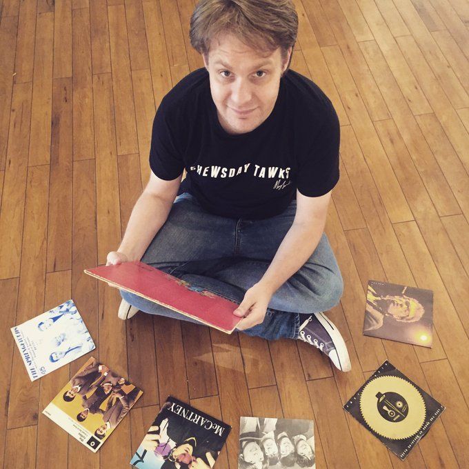 image: radio host Andy sits among his record collection