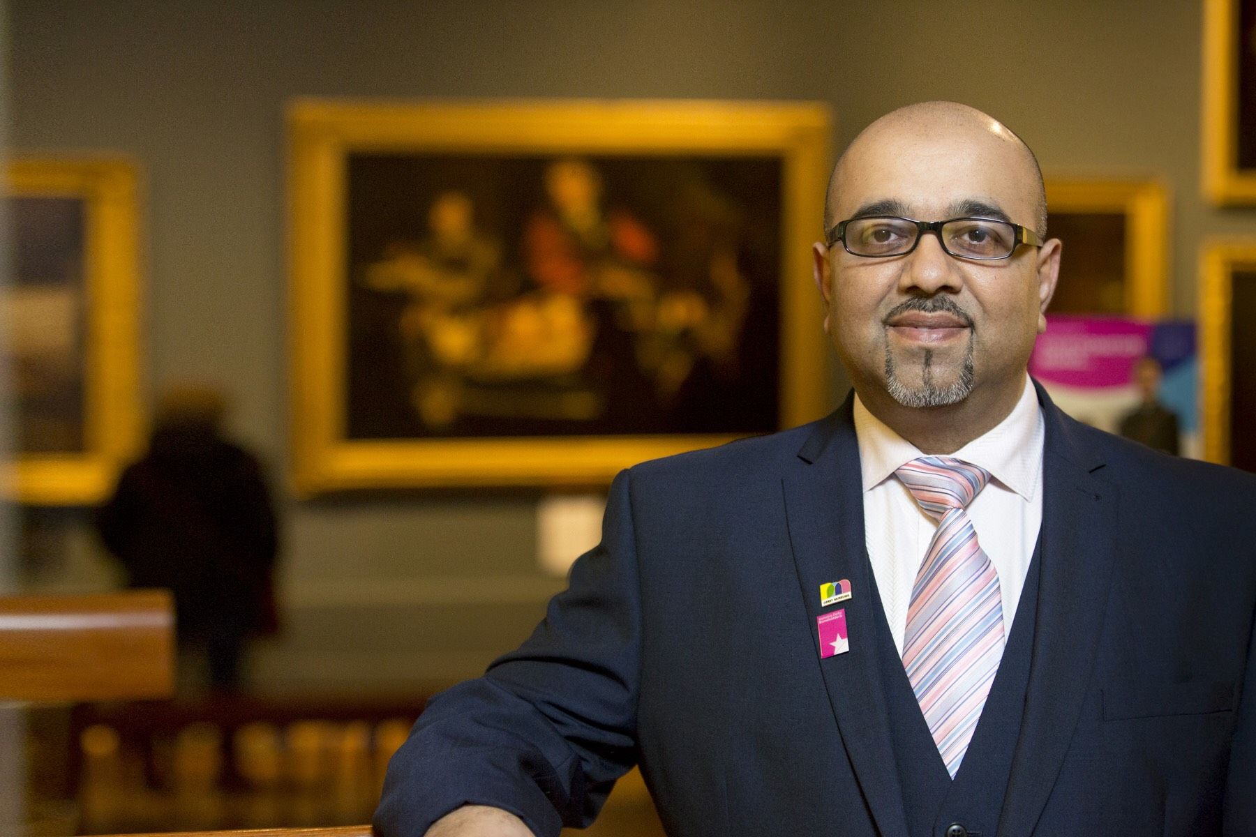 photo of Mo Suleman smiling, at Derby Museum