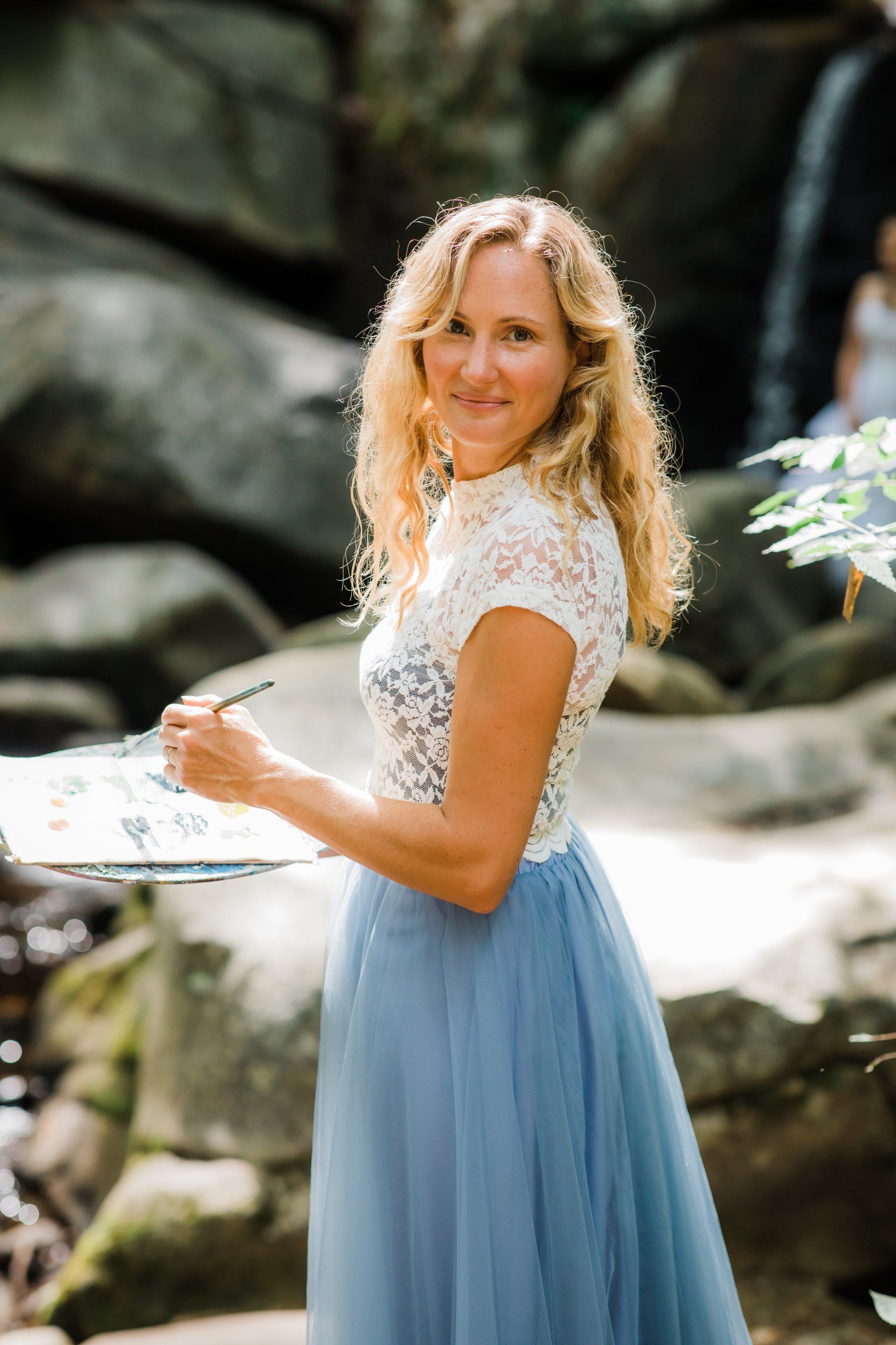 Artist Bethany Browne ready to paint the bride at a waterfall scene. 