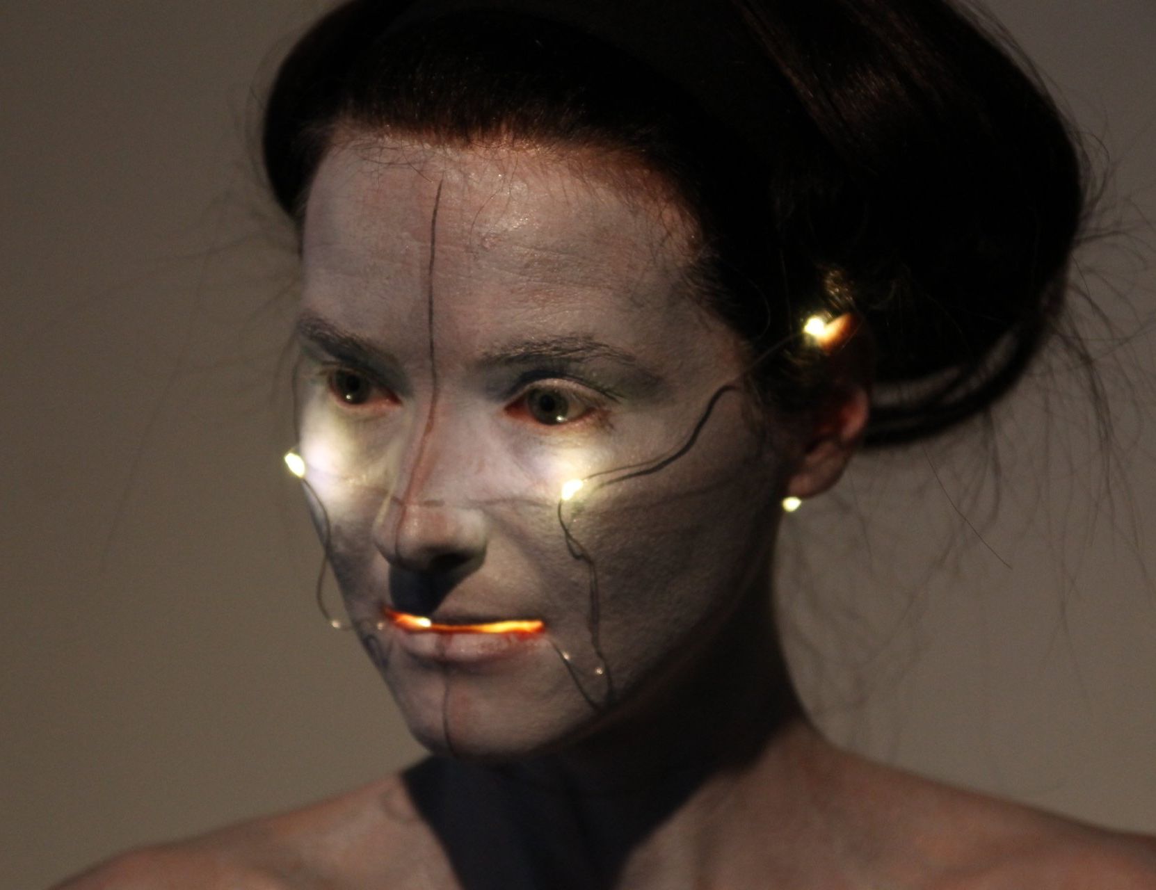 Body Art estilo Butoh en el curso de teatro físico: mujer en clase maquillada de blanco con luces en el pelo