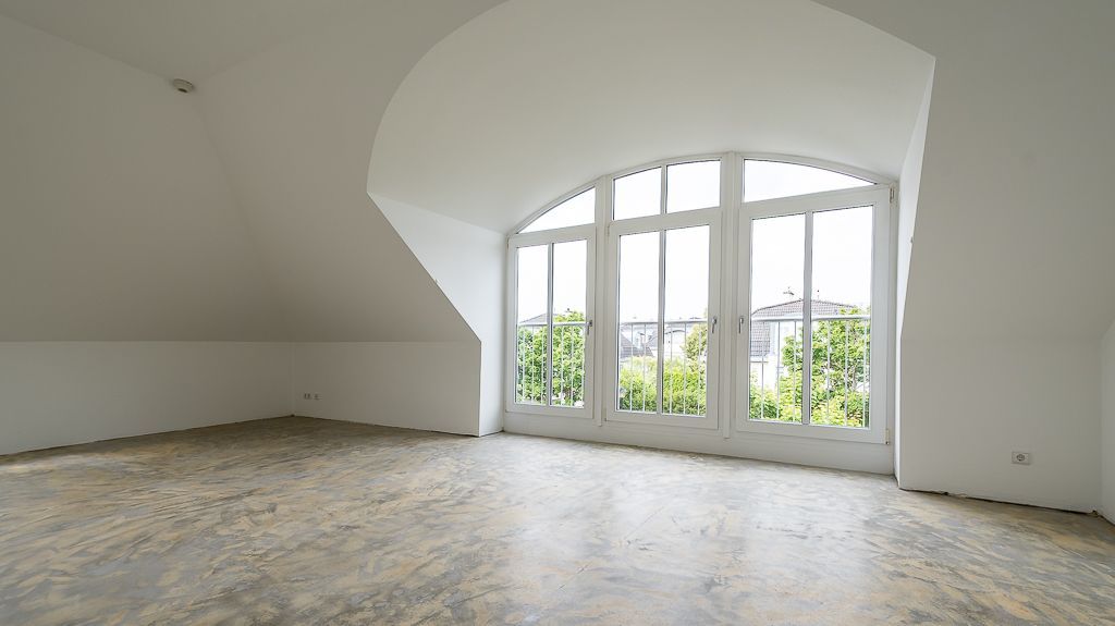 Lichtdurchflutetes Wohnzimmer mit Panoramafenstern im DG