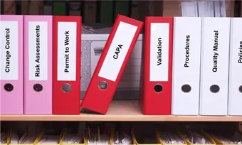 Quality Systems Folders On A Shelf