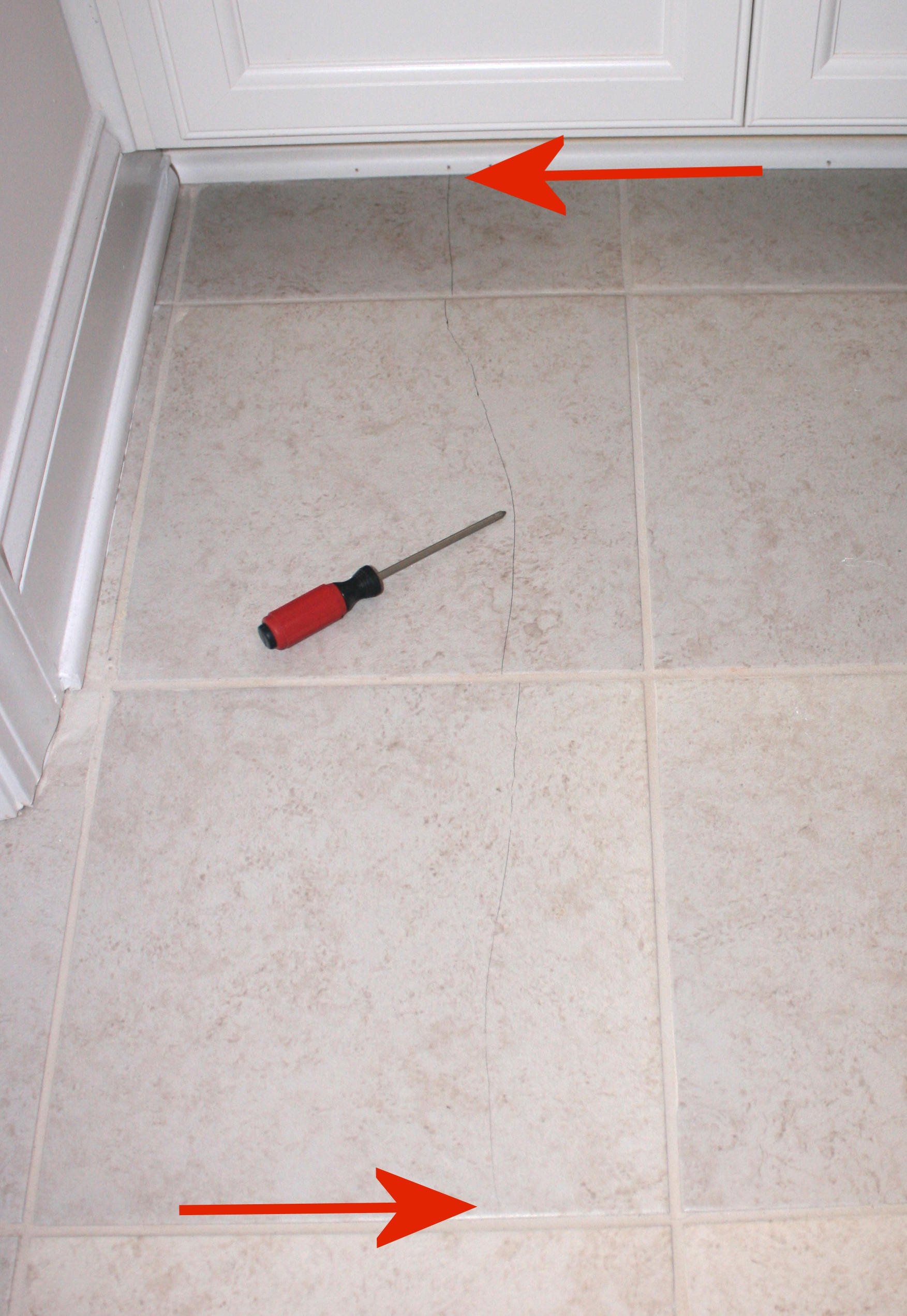 Poor quality workmanship resulting in cracked floor tiles.