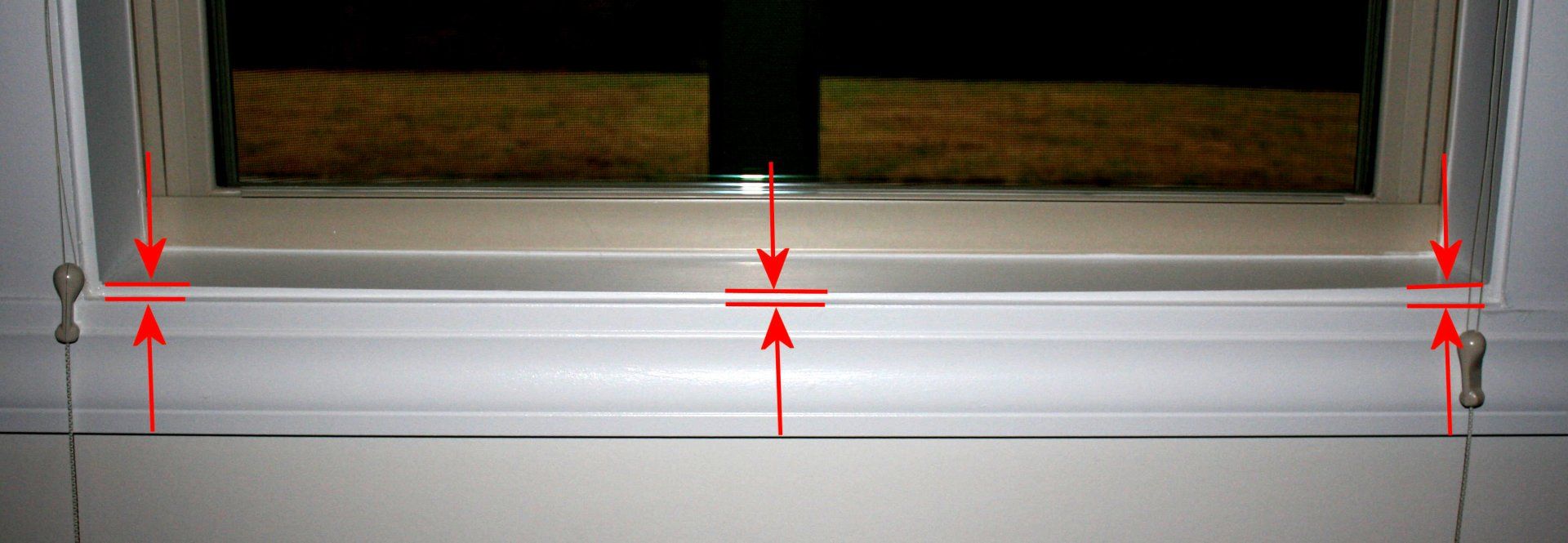Warped window sill.  Poor quality workmanship.