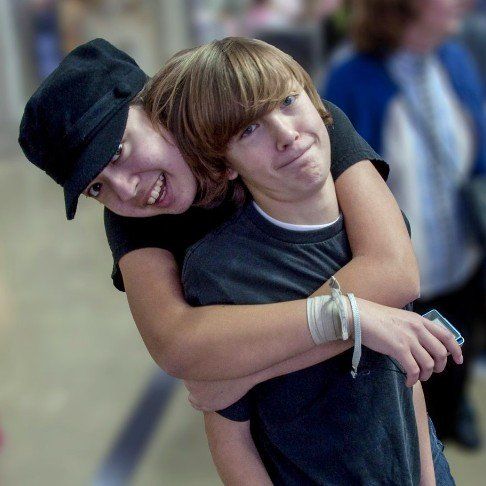Photo of two young people hugging.