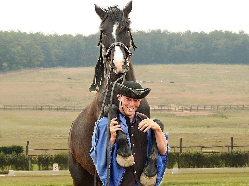 Horseman with horse on his shoulders in Hungary