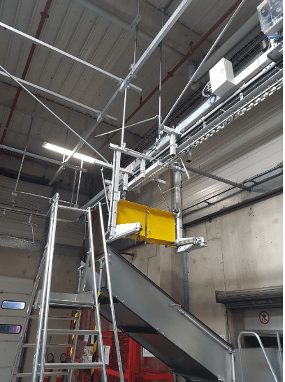 Convoyeur aérien pour plateforme logistique agroalimentaire, poste de décrochage sélectif pour évacuation déchet carton