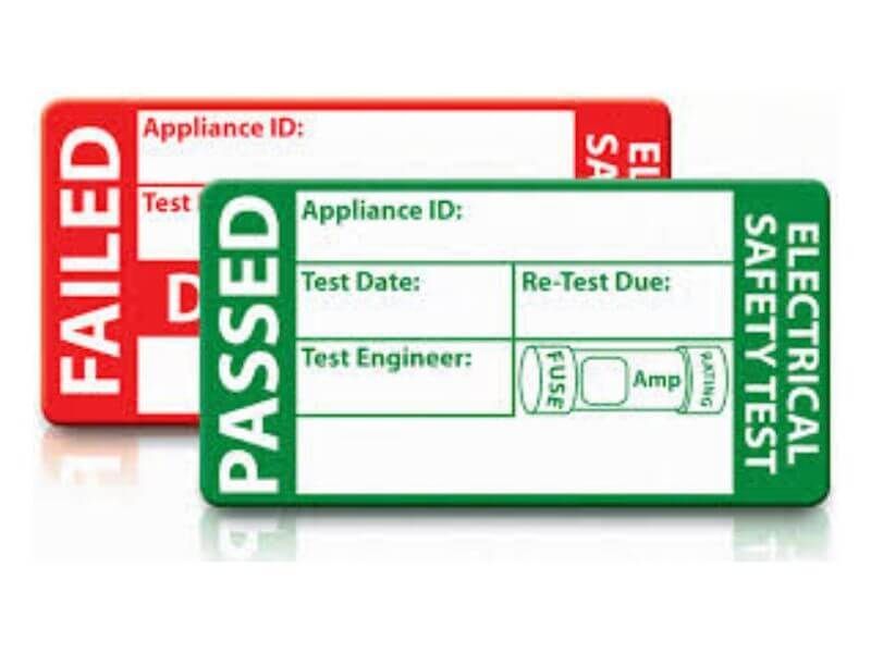Red 'failed' label sat behind a green 'passed' PAT testing label.