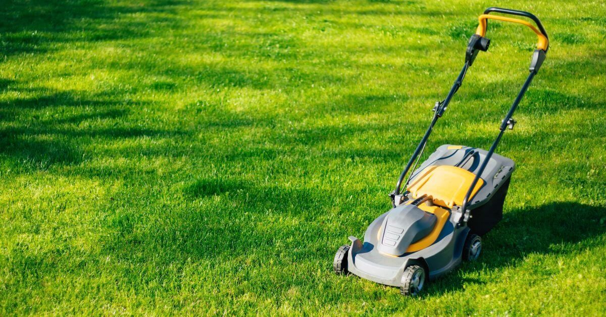 Yellow lawnmower, mowing the grass