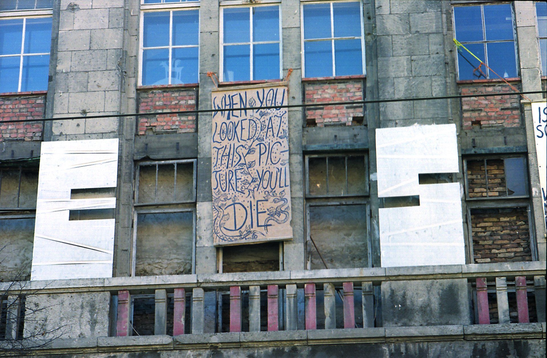 Another text-art-works that Sebastian Bieniek had hanging out of the window of his studio on the third floor of the Kunsthaus Tacheles in 1999. On the banner ist written:  Another text-art-works that Sebastian Bieniek had hanging out of the window of his studio on the third floor of the Kunsthaus Tacheles in 1999. On the banner ist written: