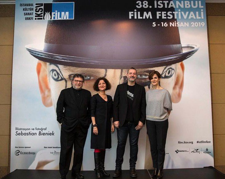 Manager Director of the 38. Instanbul Film Festivali in front of photo by Sebastian Bieniek