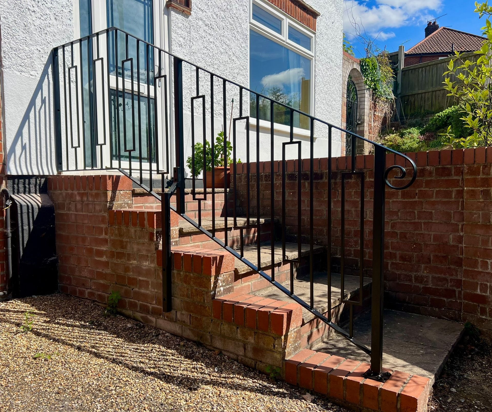Black powder coated handrail balustrade with decorative scroll. fabricated rectangle panel, galvanised and installed