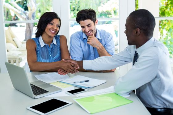 Financial Services Image of business meeting with three people.