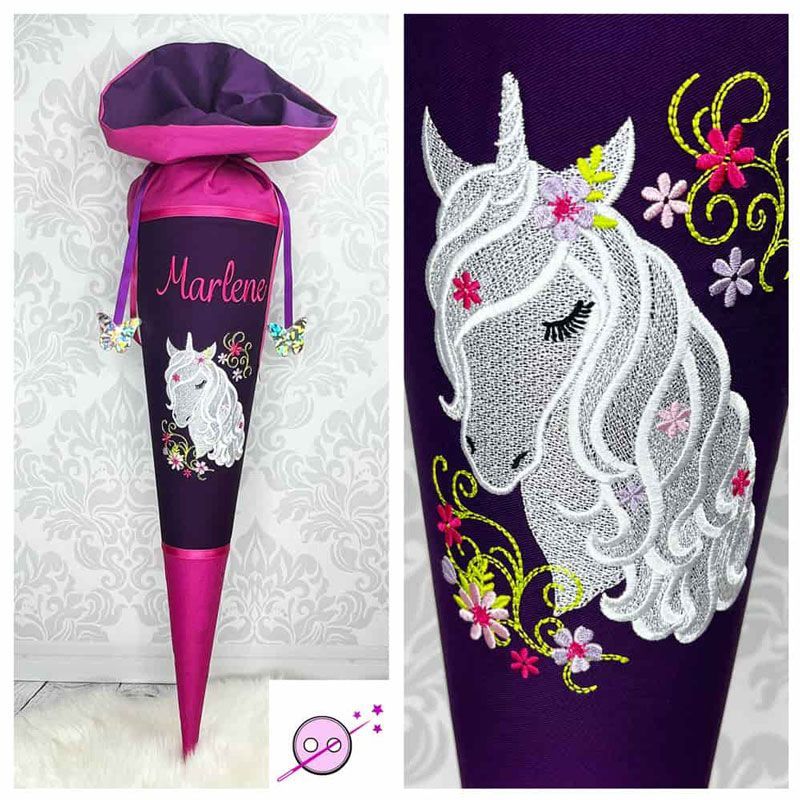 Ein Schultüte aus Stoff mit einem gestickten Einhorn in der Mitte.