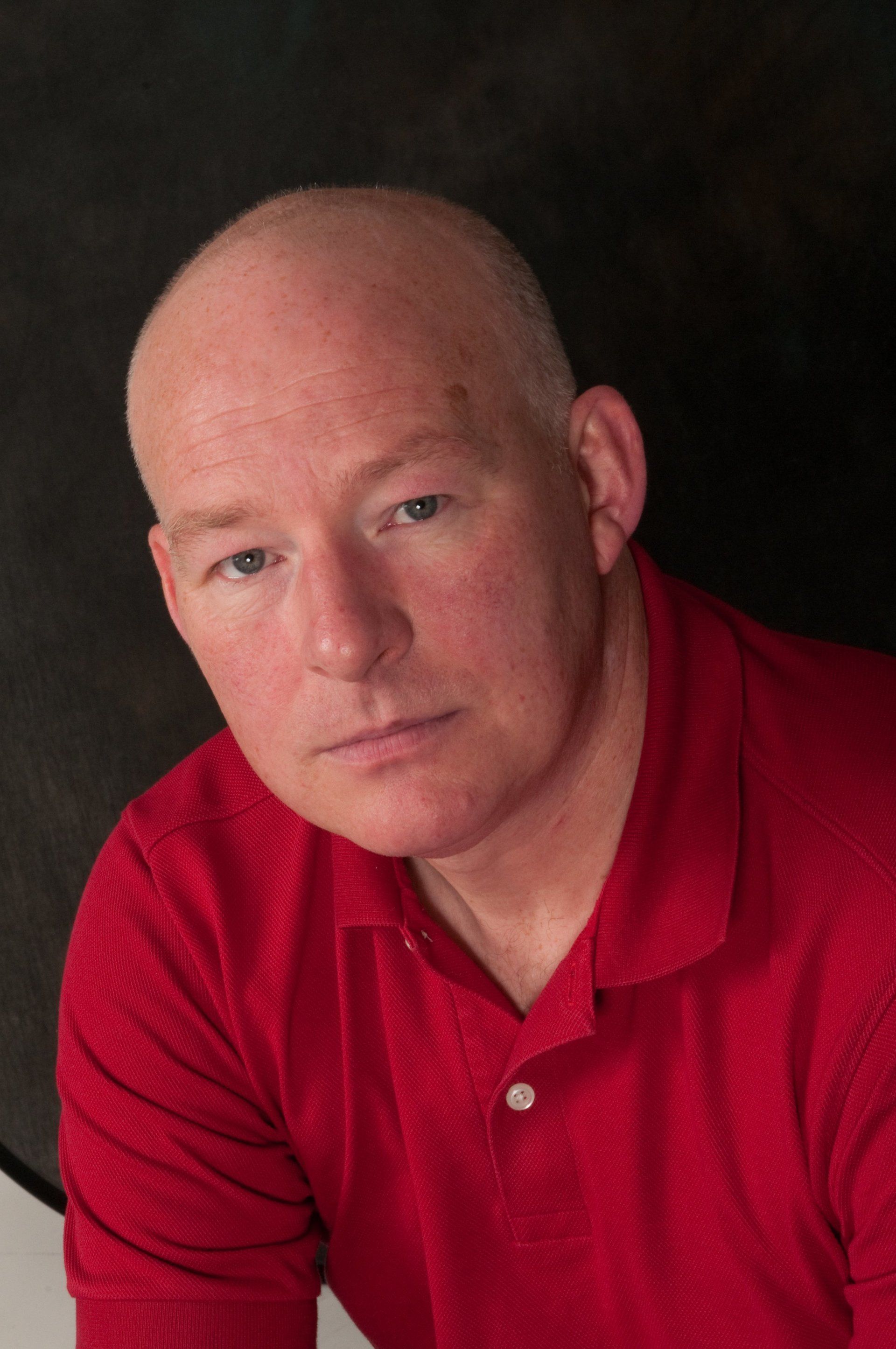 Man in red shirt on black background