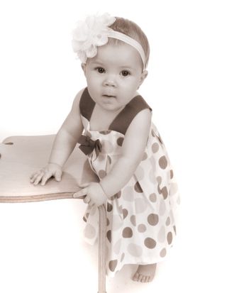 toddler standing little girl toddler with hairband standing holding onto a chair