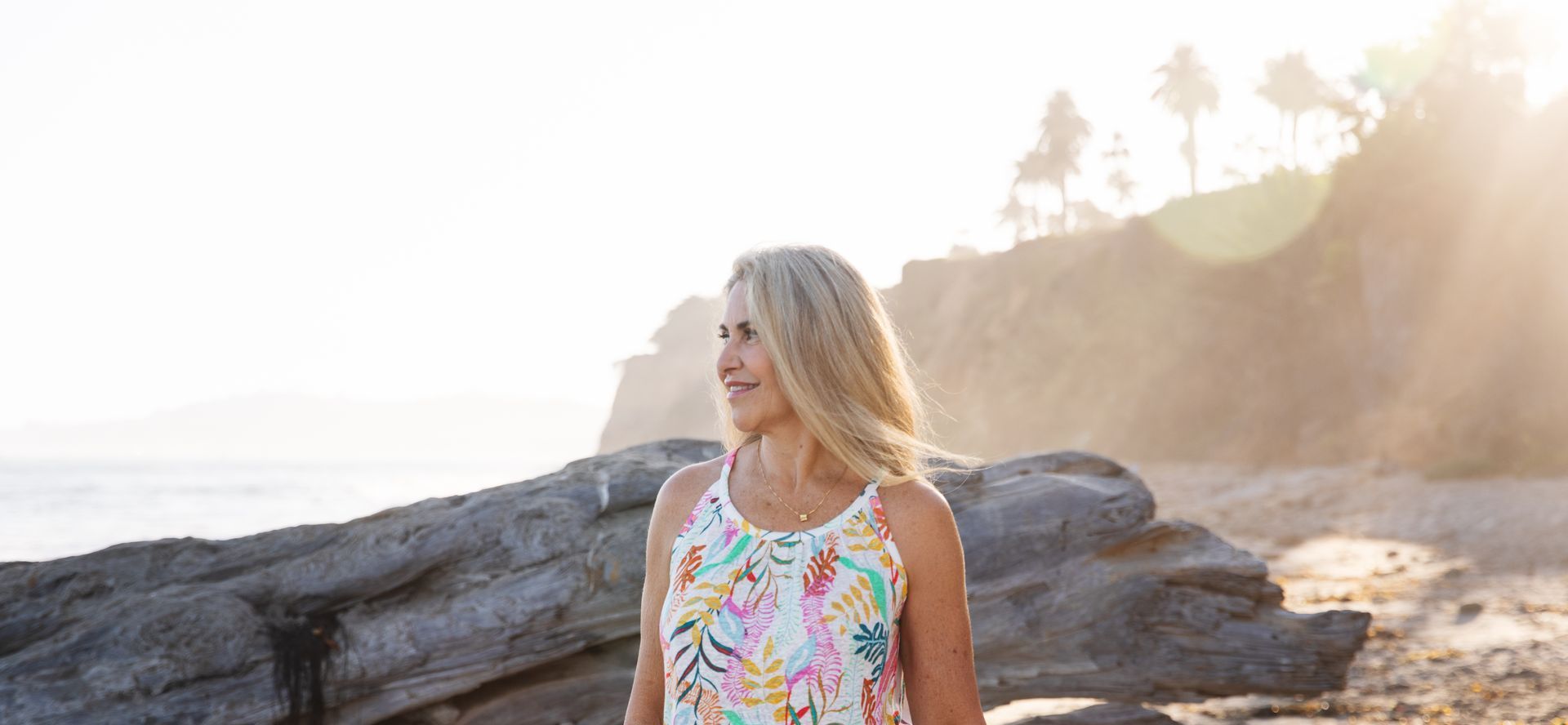 Branding headshot of a woman at Santa Barbara beach at golden hour, natural and professional style.