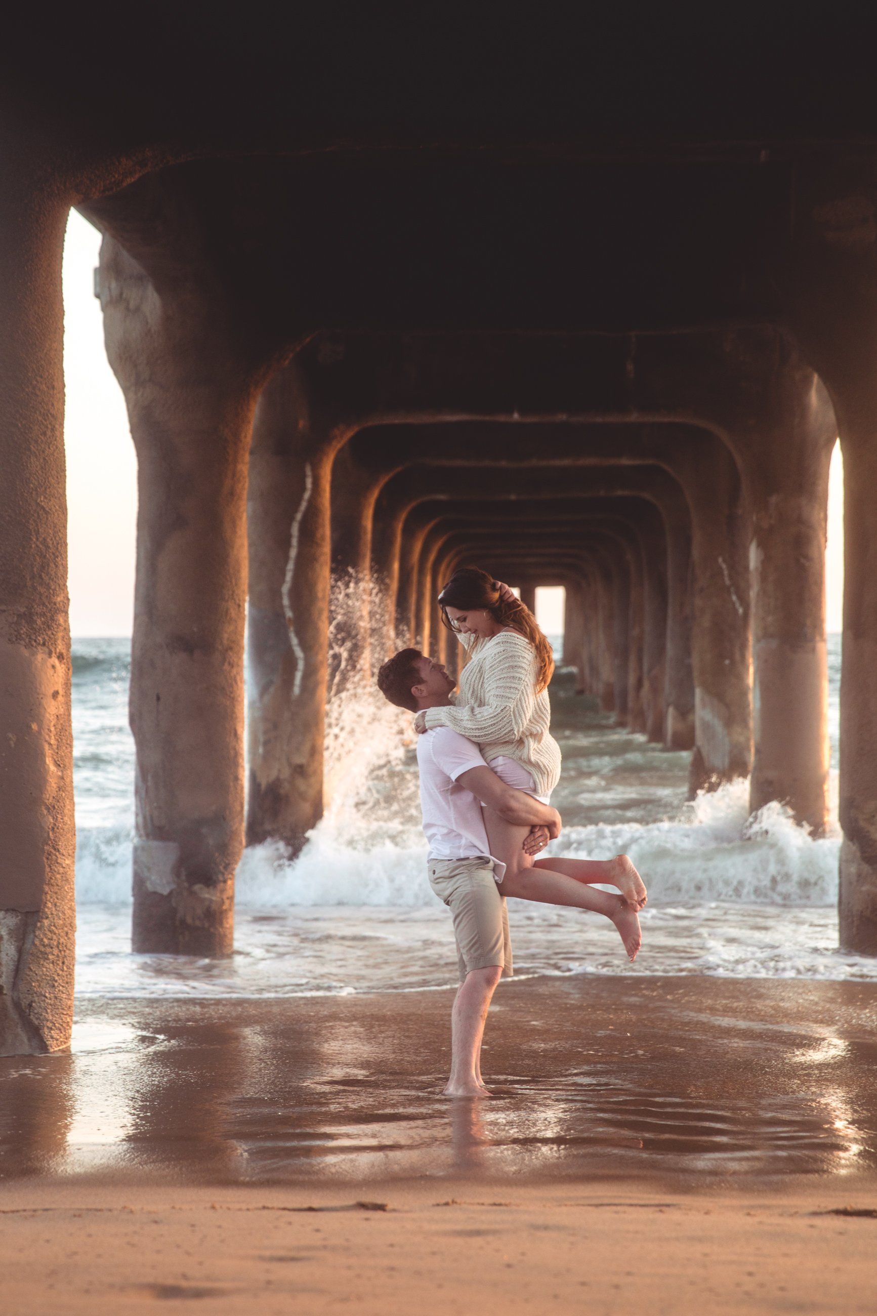 Russell and Kaylee engagement captured by Los Angeles engagement and wedding photo and video team, POP Media LA, at the Manhattan Beach Pier in Southern California..